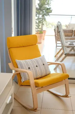 a chair with an orange seat in a room at Amazing Sea and Marina View City Center 2BDR Flat in Larnaka