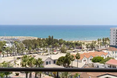 a view of the beach from the balcony of a building at Amazing Sea and Marina View City Center 2BDR Flat in Larnaka