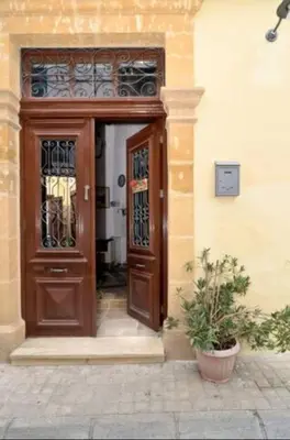 a wooden door in a building with a potted plant at Studio in the Old City of Nicosia in Nicosia
