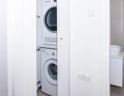 a laundry room with a washer and dryer at Venus Apartment in Larnaka