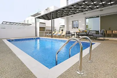 a swimming pool in the middle of a house at Villa Napa Blu in Ayia Napa
