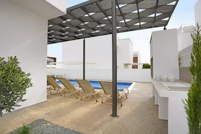 an outdoor patio with a table and chairs at Villa Napa Blu in Ayia Napa