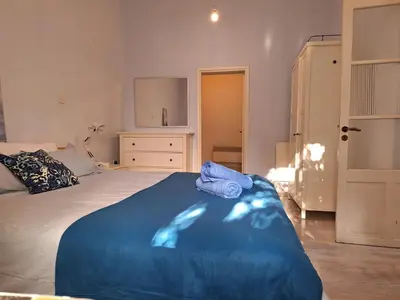 a bedroom with a bed with a blue blanket at Pavlos Place - Blue Haven in Limassol