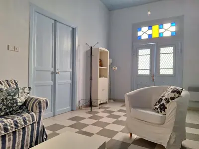 a living room with a couch and a chair at Pavlos Place - Blue Haven in Limassol