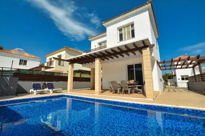 a villa with a swimming pool and a house at Villa Argyro in Ayia Napa