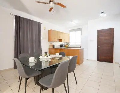 a dining room and kitchen with a table and chairs at Villa Argyro in Ayia Napa