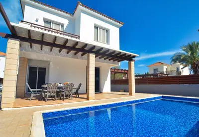 a villa with a swimming pool and a house at Villa Argyro in Ayia Napa