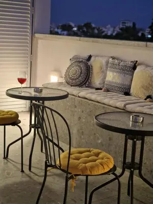two tables and chairs in a room with a couch at MARTIN Nicosia City Suites in Nicosia