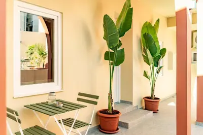 a table and two potted plants in a room at The Secret Yard in Larnaka