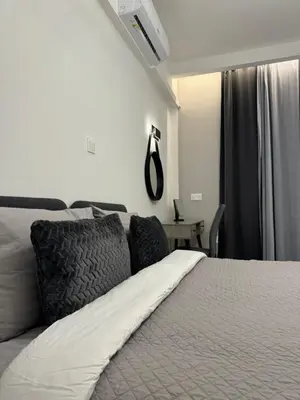 a bedroom with a white bed with a window at Spacious 1 bedroom flat in Foinikoudes! in Larnaka