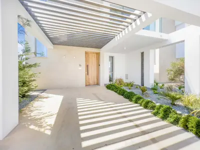 a hallway of a house with a wooden door at Azure Seaview - Garnet Villa in Protaras