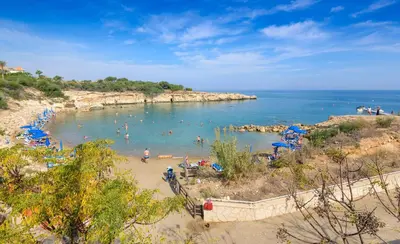 a beach with a bunch of people in the water at Azure Seaview - Ruby Villa in Protaras