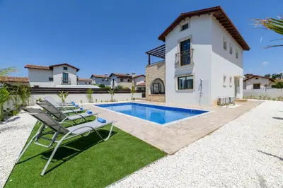 a villa with a swimming pool and a house at Kymma Villa #12 in Ayia Napa