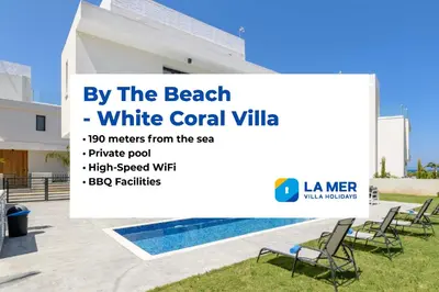 a white rental villa with a swimming pool at By The Beach - White Coral Villa in Protaras