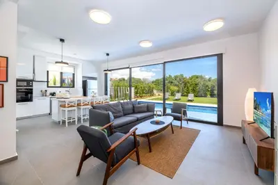 a living room with a couch and a table at By The Beach - Sea Pearl Villa in Protaras