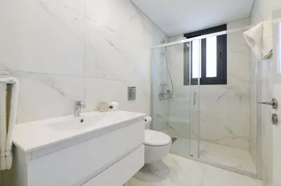 a bathroom with a toilet and a sink and a shower at By The Beach - Sea Pearl Villa in Protaras