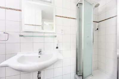 a white bathroom with a sink and a shower at Sunrise Bay Villa #3 in Protaras