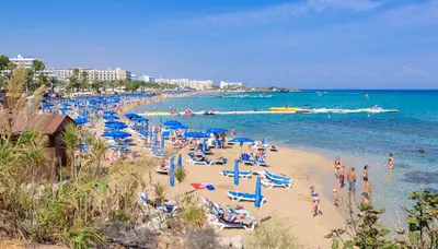 a beach with a lot of people on the sand and the water at Sunrise Bay Villa #4 in Protaras