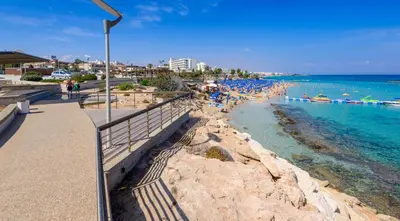 a beach with a crowd of people and the ocean at Sunrise Bay Villa #4 in Protaras