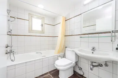 a bathroom with a toilet and a sink and a tub at Sunrise Bay Villa #4 in Protaras