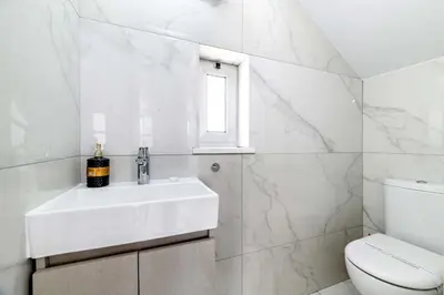 a white bathroom with a sink and a toilet at Mylos Lifestyle Seaview Villa #37 in Protaras