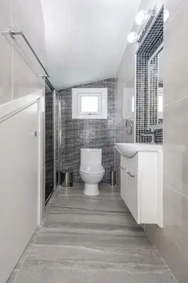 a white bathroom with a toilet and a sink at Green Bay Villa #15 in Protaras