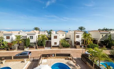 a view of a villa with houses in the background at Villa Greco Mare #20 in Protaras
