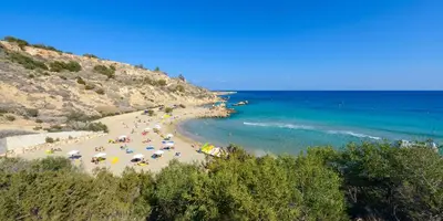 a beach with a bunch of people and the ocean at Villa Greco Mare #40 in Protaras
