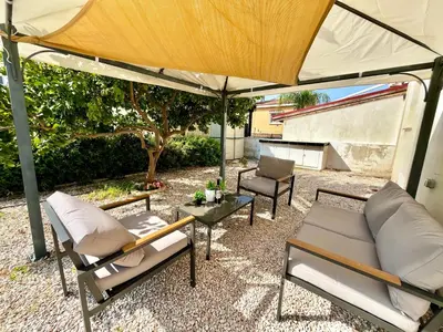 a patio with two chairs and an umbrella at STAY Tranquility Cove in Larnaka