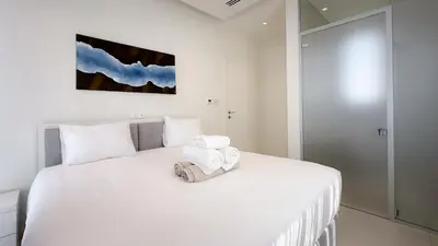 a bedroom with a white bed with two towels on it at City Napa Seaview Villas - Villa 5 in Ayia Napa