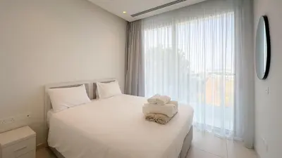 a bedroom with a bed with a stuffed animal on it at City Napa Seaview Villas - Villa 5 in Ayia Napa