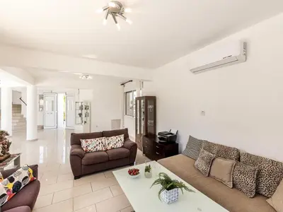 a living room with a couch and a table at Villa Alexandra in Protaras