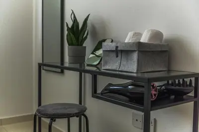 a black shelf with a hair dryer and a plant at Creative 1br Pool view Apt with covered parking in Livadhia