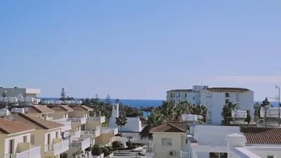 a view of a city with houses and the ocean at Nissi Golden Sands Privileges Apt in Ayia Napa