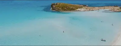 an aerial view of a beach with people in the water at Nissi Golden Sands Privileges Apt in Ayia Napa