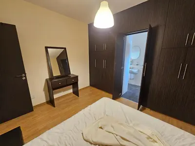 a bedroom with a bed and a mirror and a bathroom at STEFARIS sea & mountain view in Larnaka