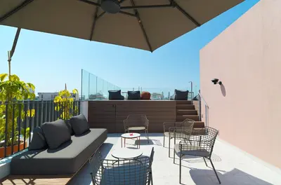 a patio with a couch and chairs on a balcony at Alinea Market Agora Square in Limassol