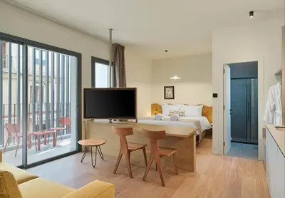 a hotel room with a bed and a tv at Alinea Market Agora Square in Limassol