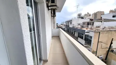 a balcony with a view of a city at City Center: Your Urban Retreat- 100m to the beach in Larnaka