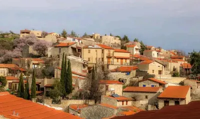 a group of buildings on a hill with roofs at Lofou Traditional Stone House in Lofou