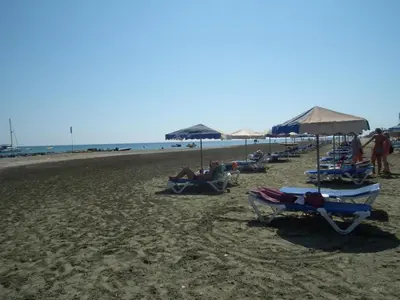 a group of people sitting in chairs on the beach at Sunrise Villa in Pervolia
