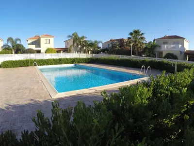 a swimming pool in the backyard of a house at Sunrise Villa in Pervolia