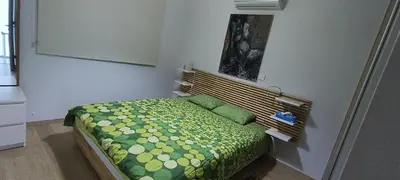 a small bedroom with a bed with green and yellow sheets at Sunrise Villa in Pervolia