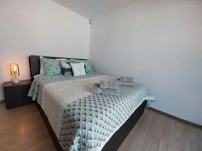 a bedroom with a bed with a comforter at Coco De Mer 408 in Limassol