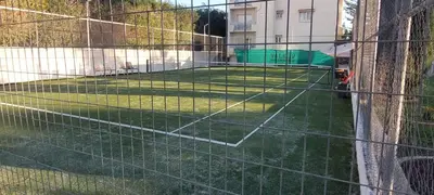 a tennis court is seen through a fence at Coco De Mer 408 in Limassol