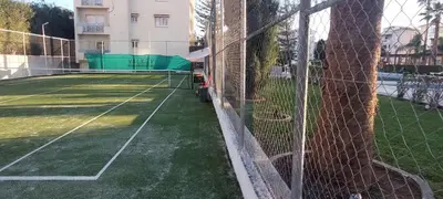 a tennis court with a net on a tennis court at Coco De Mer 408 in Limassol