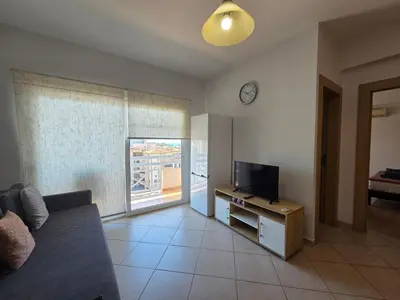 a living room with a couch and a tv at Coco De Mer 408 in Limassol
