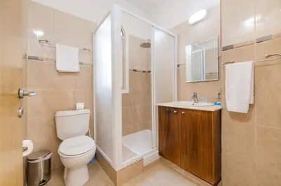 a bathroom with a toilet and a shower and a sink at Alex Villa Kapparis in Protaras
