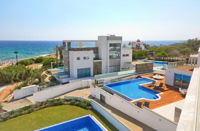 an aerial view of a house with a swimming pool and the ocean at Sea Pearl Seaview Villa - Oriana in Ayia Napa