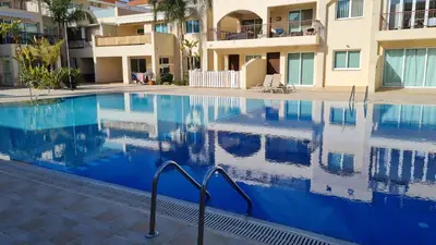 a large swimming pool in front of a building at The Olive Grove Escape, Eleonas Apts in Sotira